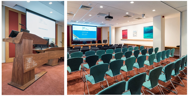 Maoilbhríde Conference Room: Interior view. This image shows the inside of the Maoilbhríde Conference Room. This image shows the top of the room and the podium and top table. The podium is height adjustable and accessible. The second image shows the Maoilbhríde Room and the inside of the room from the back of the room with seating arranged for a seminar talk or oral hearing. However, the room can be re-arranged to accomodate the requirements of the event.