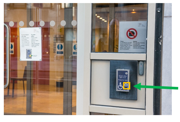 Front door close up. This image shows the front door and buzzer area. The button to operate the buzzer has a yellow box around it and a green arrow pointing to it from the right-hand side.