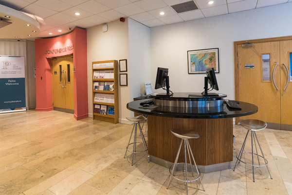 Lobby area. This image shows the lobby area with the publications stand, computers for public use, and entrances to Maoilbhríde and Parnell Rooms.