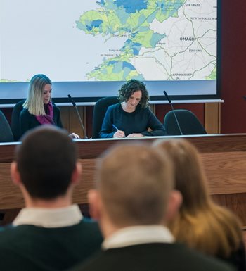 An Bord Pleanála Inspector opening an oral hearing and assisted by administrative staff.
