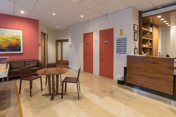 Entrance in front of porch doors: facing left (nine o'clock position). When you are stood with the porch sliding doors behind you, and face to the left-hand side (9 o'clock position), there are the accessible toilets, entrances to the Cathal Brugha and Seán MacDiarmada rooms, seating and tables where you can wait for An Bord Pleanála staff or look at decided files through the public access service.